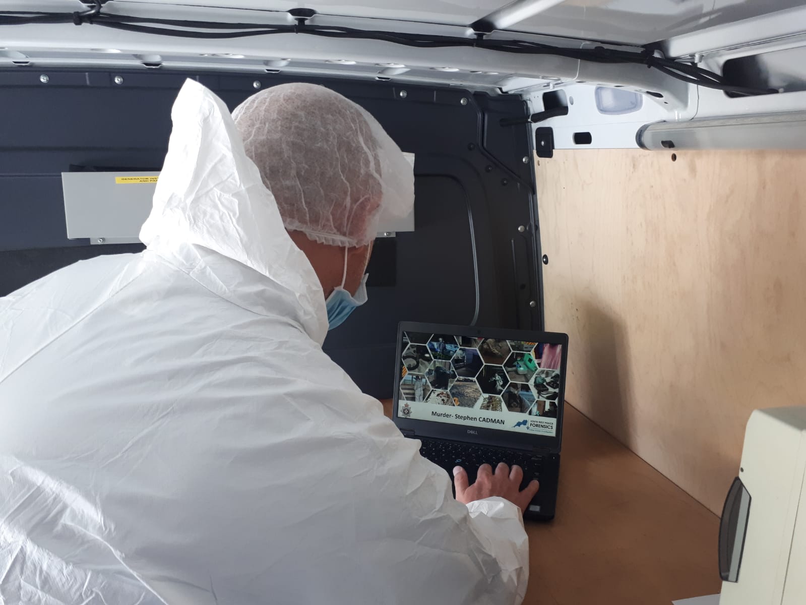 Forensics Officer at a laptop 