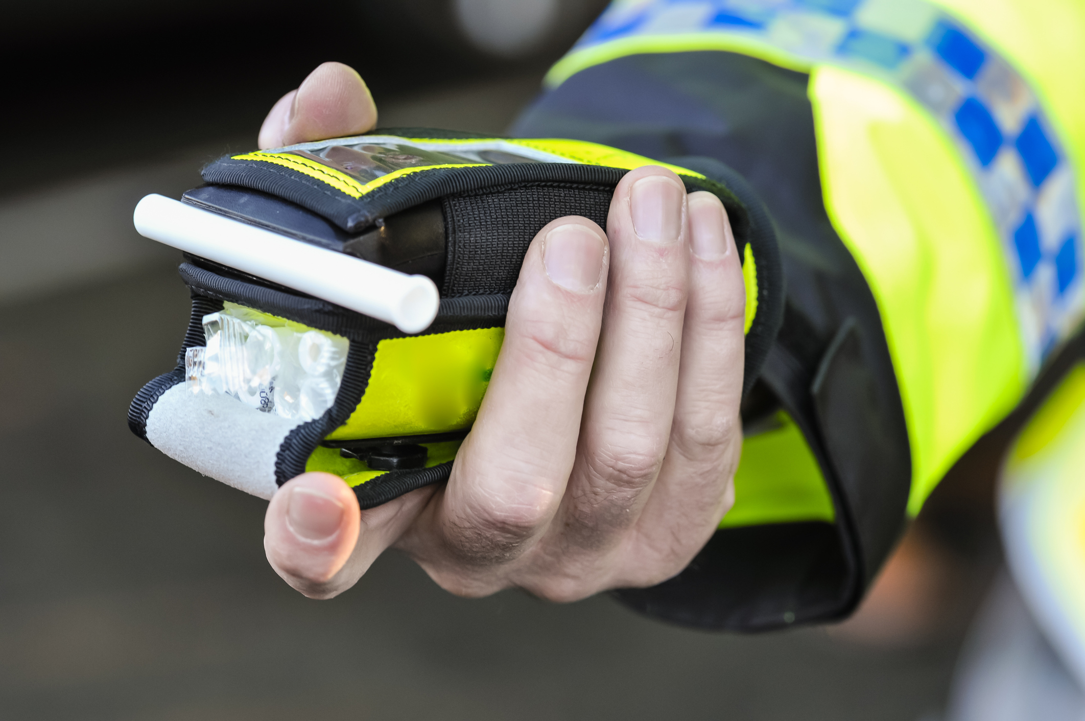Police officer holding a breath test.