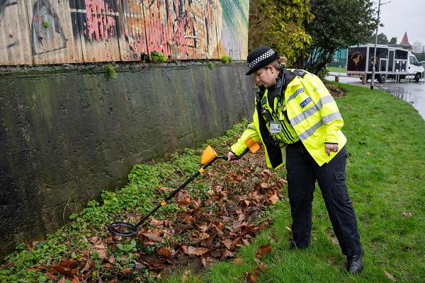 Officer conducting knife safety sweep