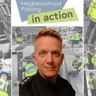 Police officer in front of picture collage