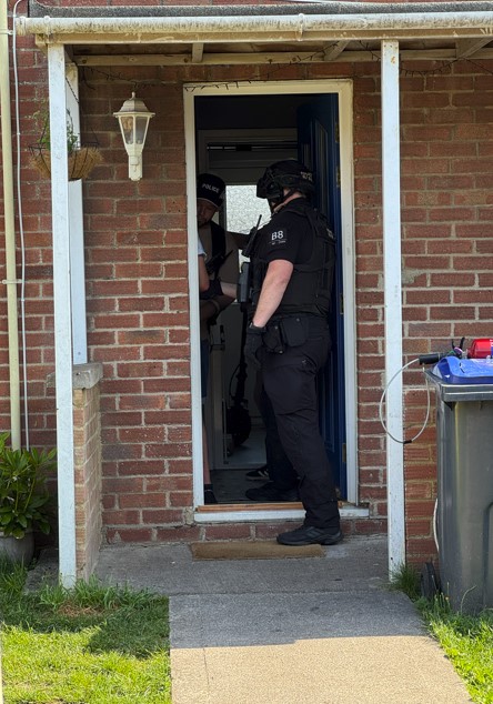 Images of officers at front door during a warrant