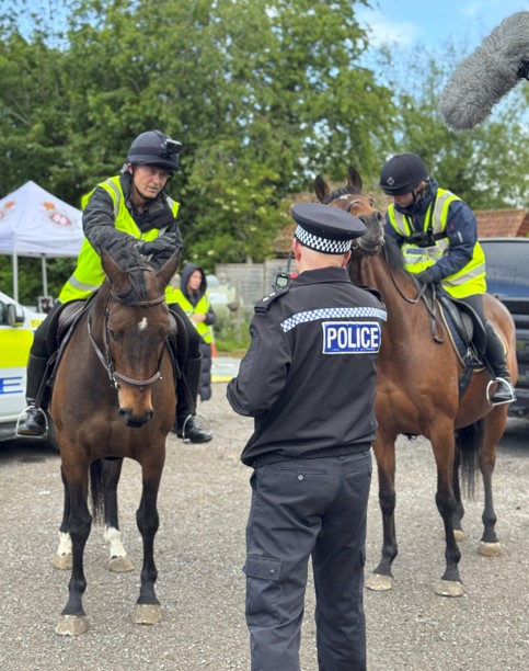 Image of Jerry on horseback talking to police
