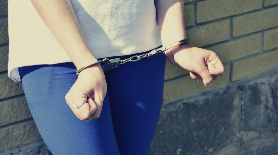 stock image of hands in handcuffs