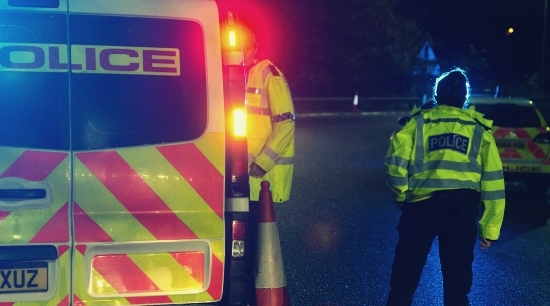 Image of police and van at night