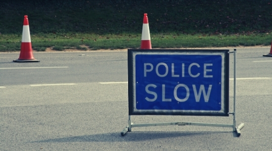 stock image of a police slow sign at a collision